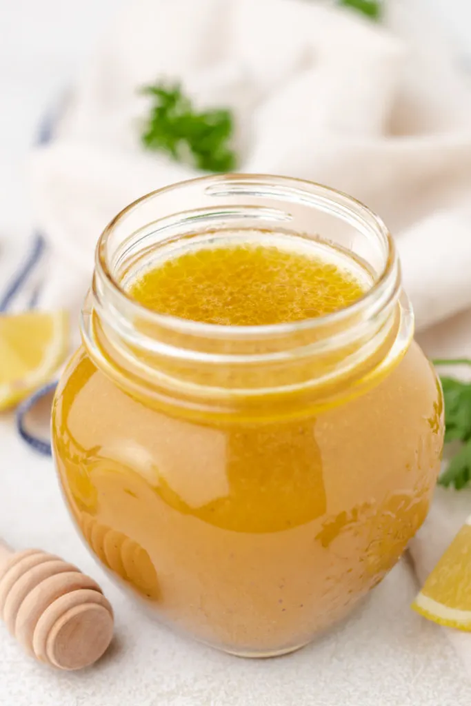 Honey lemon salad dressing in a glass jar.