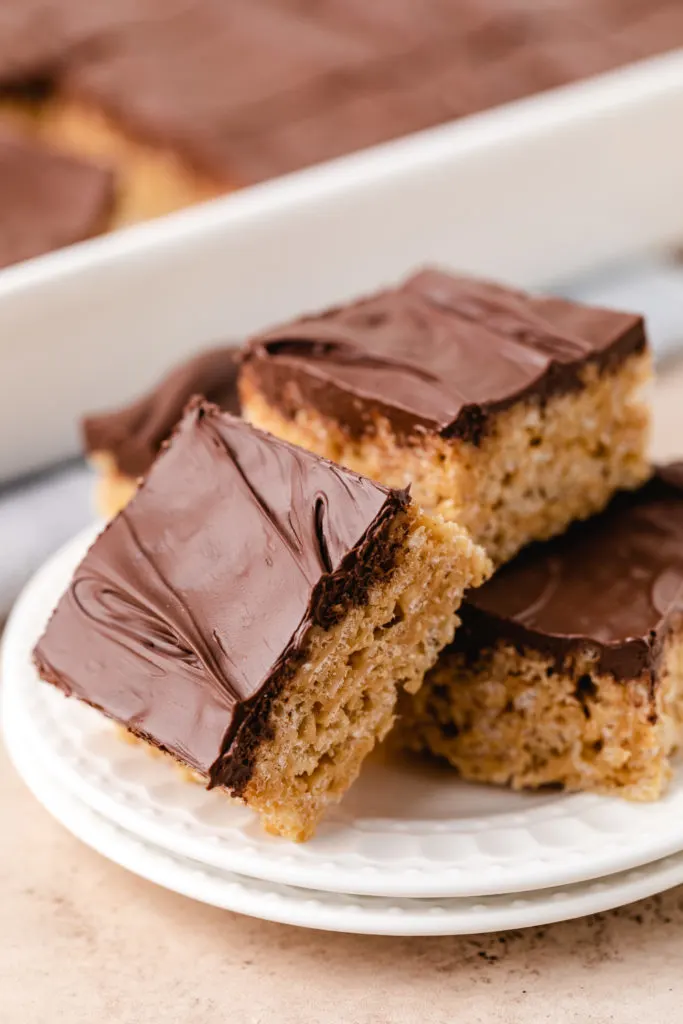 Plate of chocolate covered rice krispie treats.