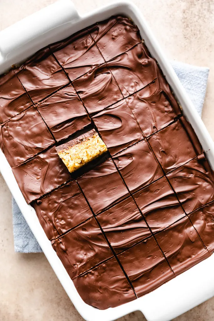 Top down view of a pan of cut peanut butter rice krispie treats.