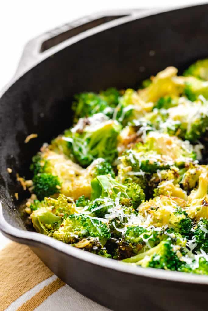 Side view of cooked broccoli in a pan.
