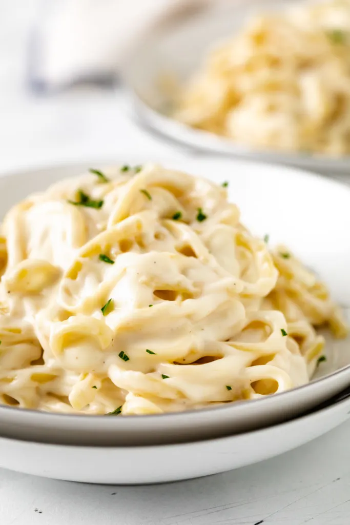 Bowl of pasta and cream sauce.