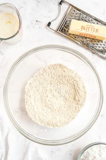 Flour, sugar, baking powder, poppy seeds, and salt in a bowl.