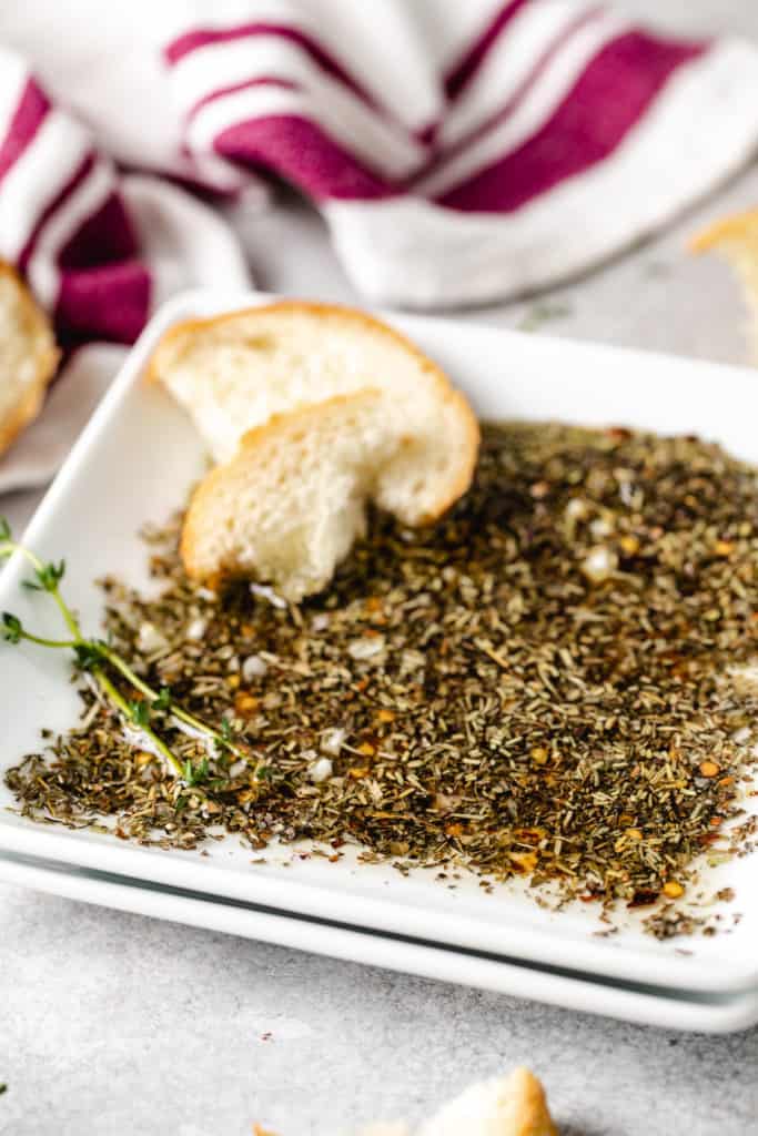 Side view of a bowl of dipping oil for bread.