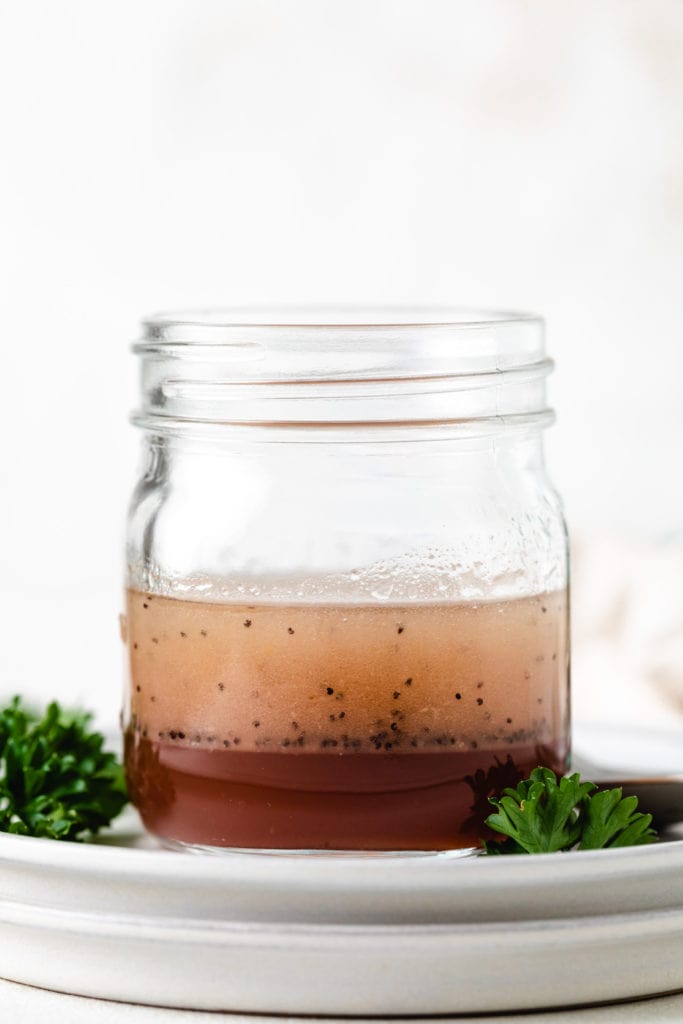 Poppy seeds in a jar of salad dressing.