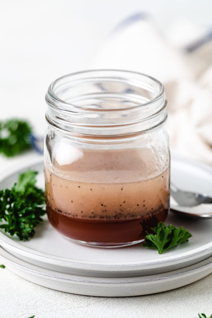 Pink colored salad dressing in a jar.