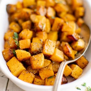 Side view of roasted butternut squash in a serving dish.