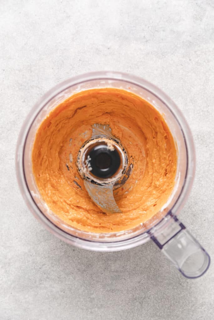 Flavored cream cheese in a food processor.