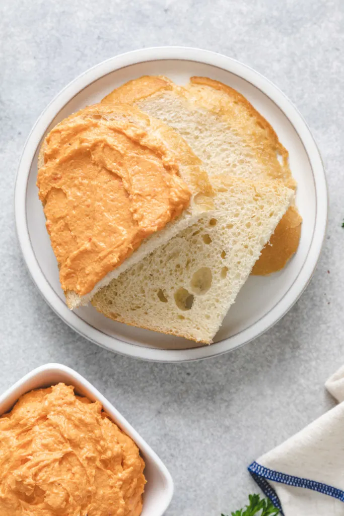 Top down view of cream cheese spread over a piece of bread.