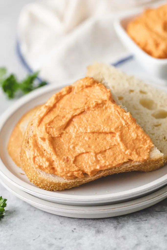 Cream cheese spread onto a piece of bread.