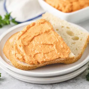 Close up view of garlic and sun dried tomato cream cheese on bread.