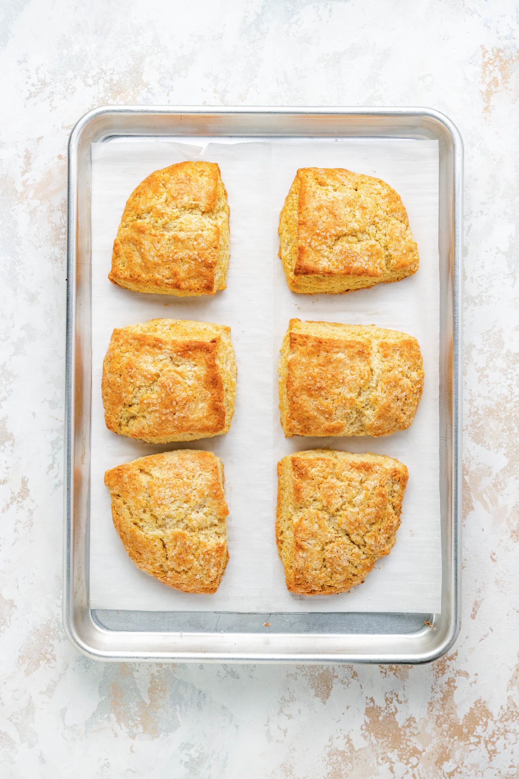 Baked shortcake biscuits on a pan.