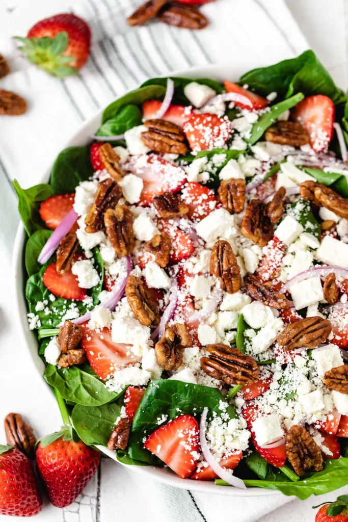 Strawberries and spinach in a salad.