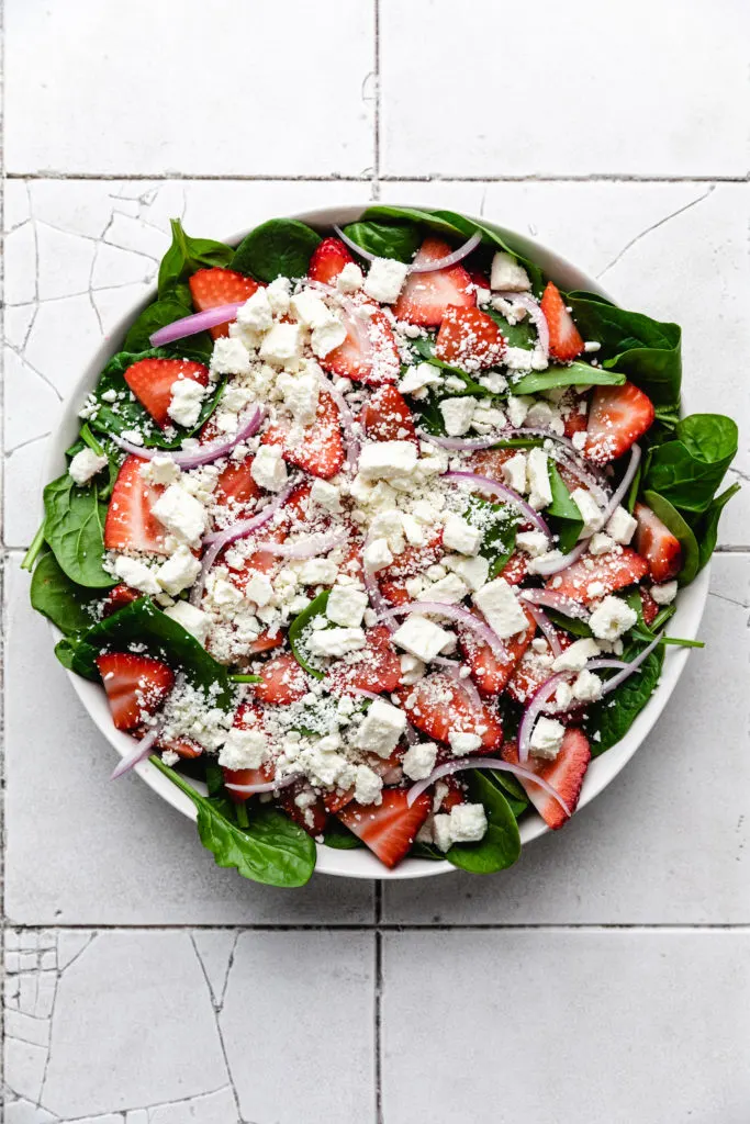 Feta cheese sprinkled over a fruit salad.