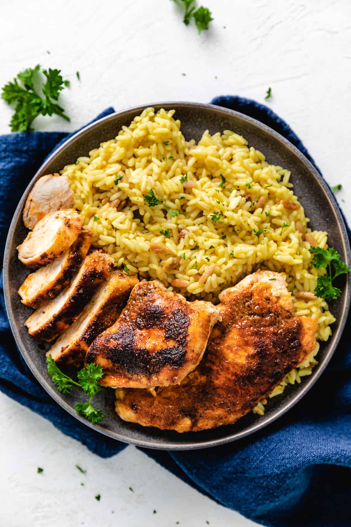 Seasoned, baked chicken on a plate.