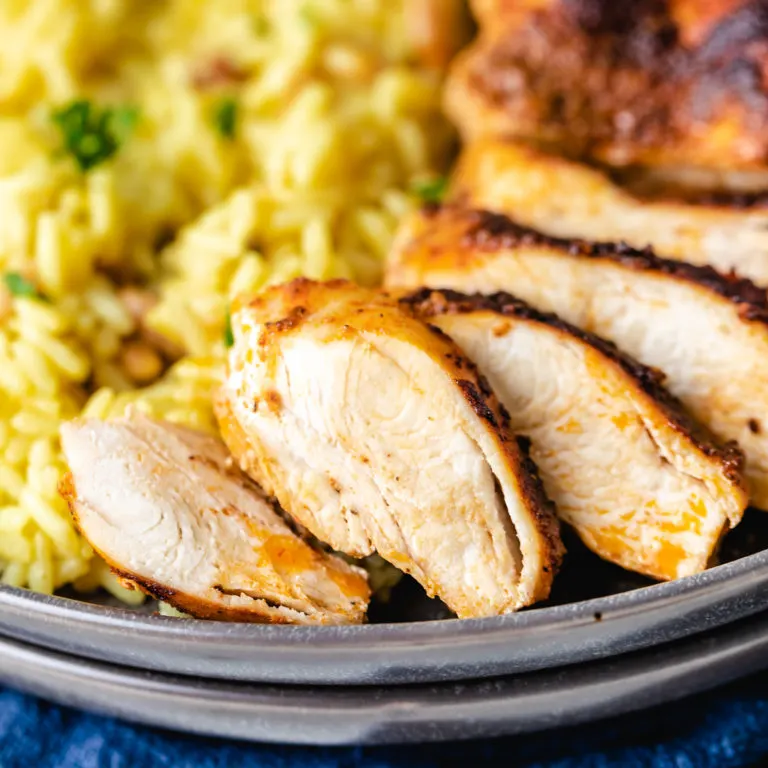 Close up view of sliced chicken on a plate.