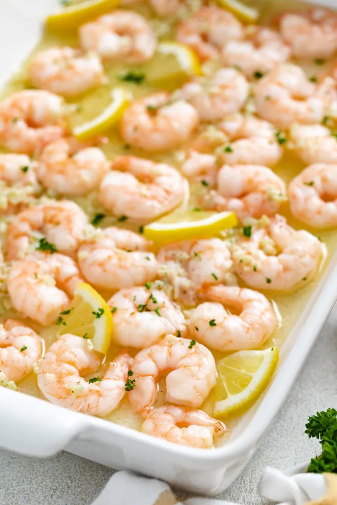 Lemon butter shrimp in a white dish.