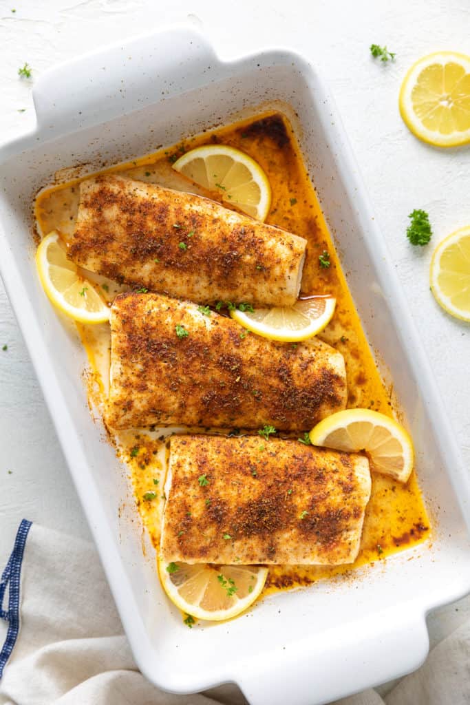 Top down view of baked fish in a pan.