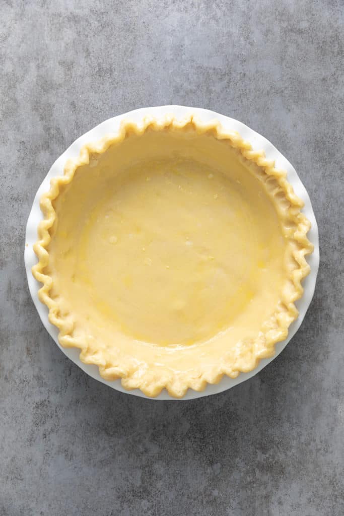 Egg wash brushed over an unbaked pie crust.