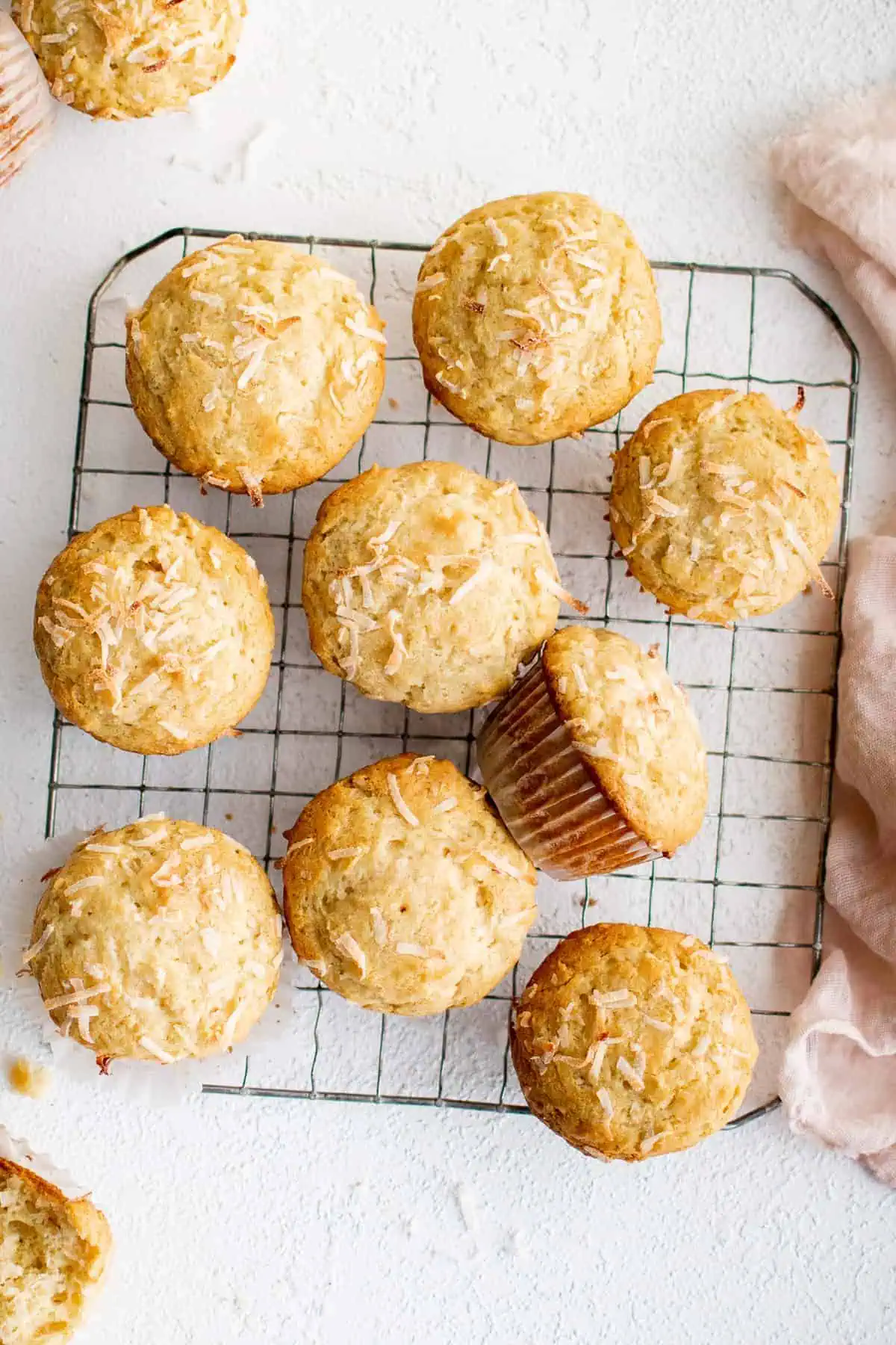 Top down view of a batch of cooling coconut muffins.