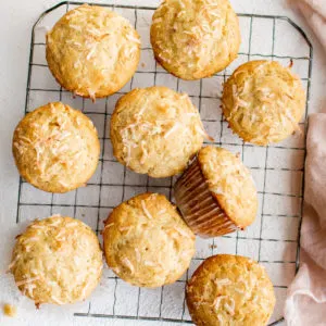 Top down view of several muffins on a rack.