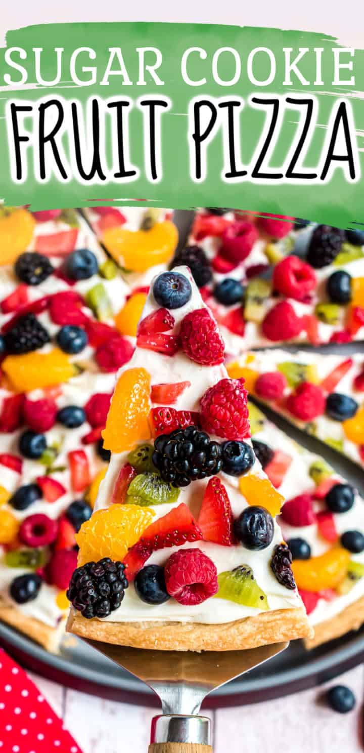 Close up view of a spatula holding a slice of fruit pizza.