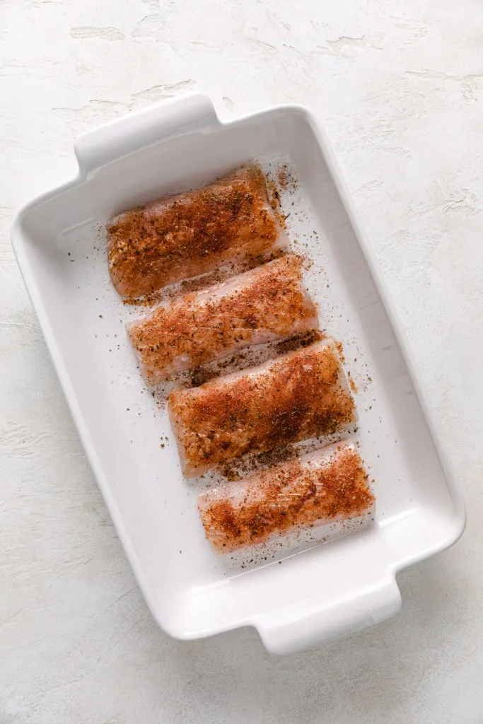 Pan of seasoned fish filets.