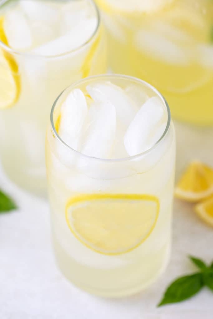 Top down view of glasses of lemonade on ice.