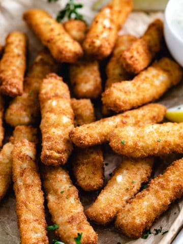 Close up view of fish sticks on a pan.