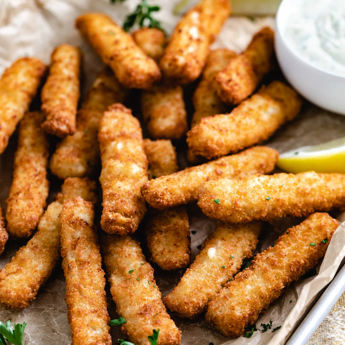 Close up view of fish sticks on a pan.