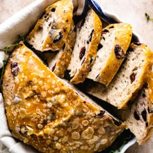 Close up view of the top of a loaf of olive bread.