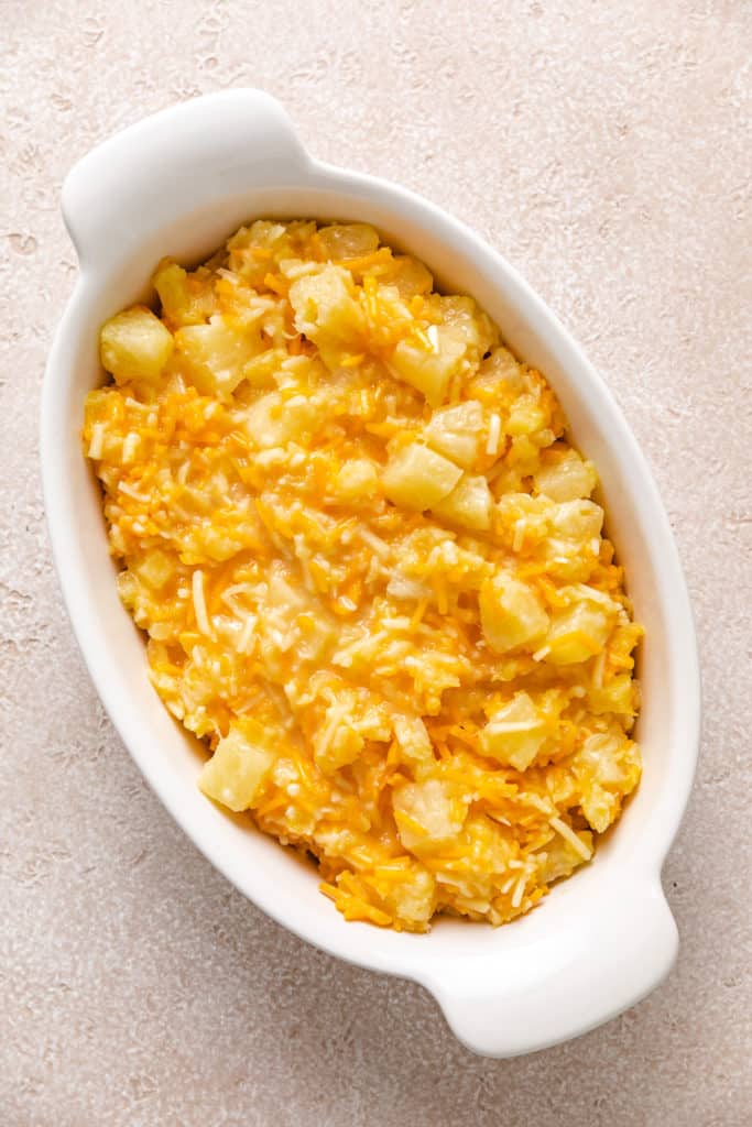 Pineapple, cheese and sugar mixture in a casserole dish.