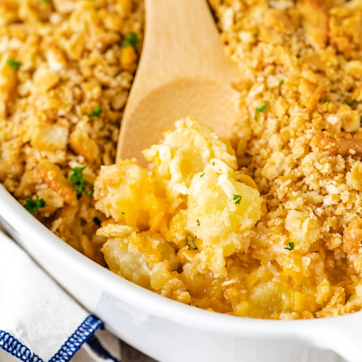 Close up view of a spoon scooping fruit casserole.