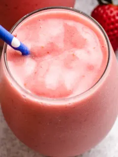 Blue and white straw in a strawberry pineapple smoothie.