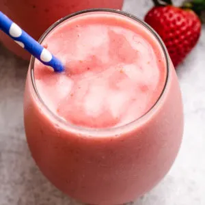 Blue and white straw in a strawberry pineapple smoothie.