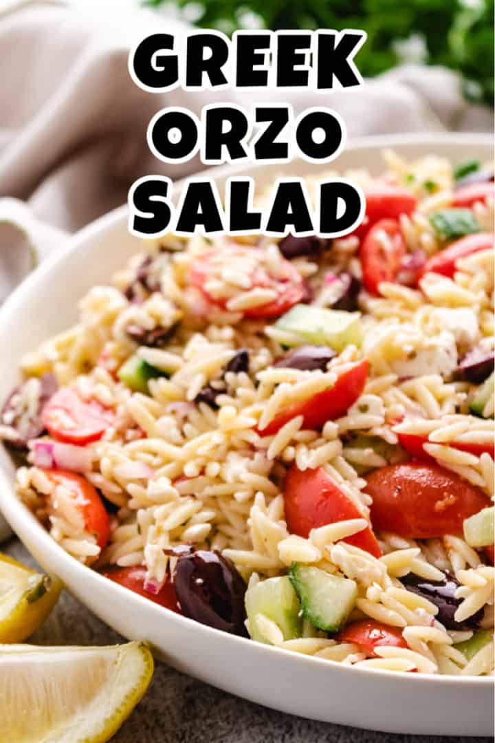 White serving dish filled with greek orzo salad.