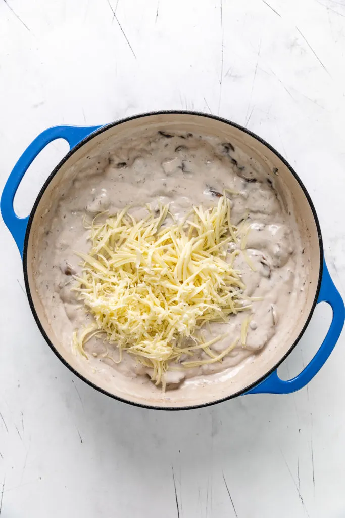 Cheese added to a creamy mushroom sauce.