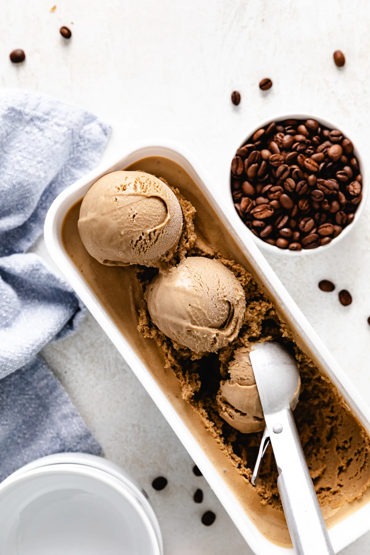 Scoops of coffee ice cream in a container.