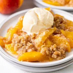 Close up view of peach crisp on gray plates.