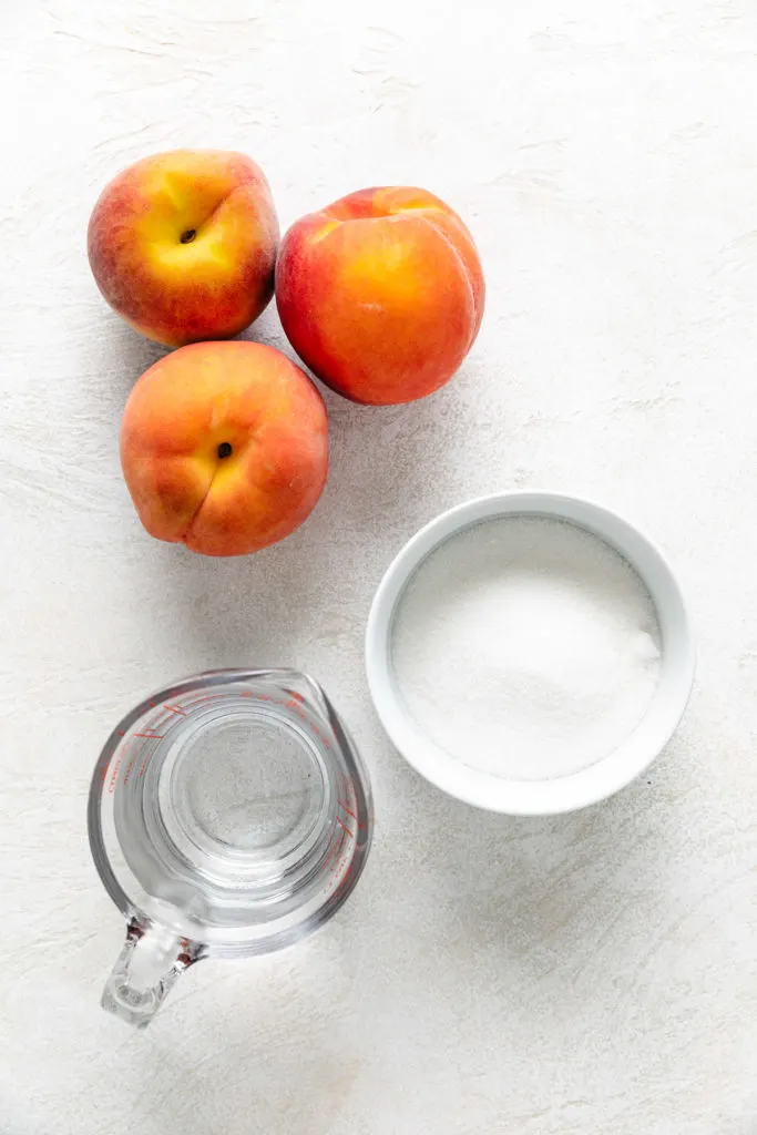 Peachses, water and sugar needed to make peach simple syrup.