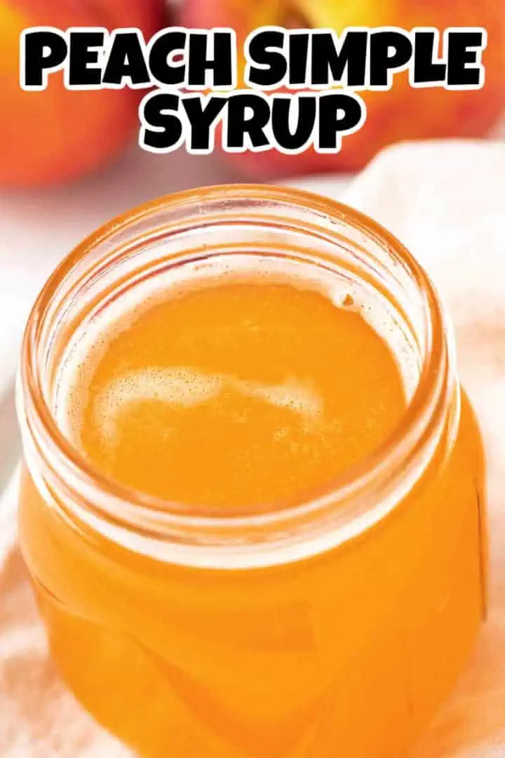 Close up view of a jar of peach flavored simple syrup.