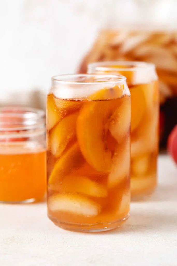 Side view of peach flavored tea in glasses.