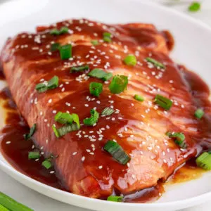 Close up view of teriyaki salmon on a platter.