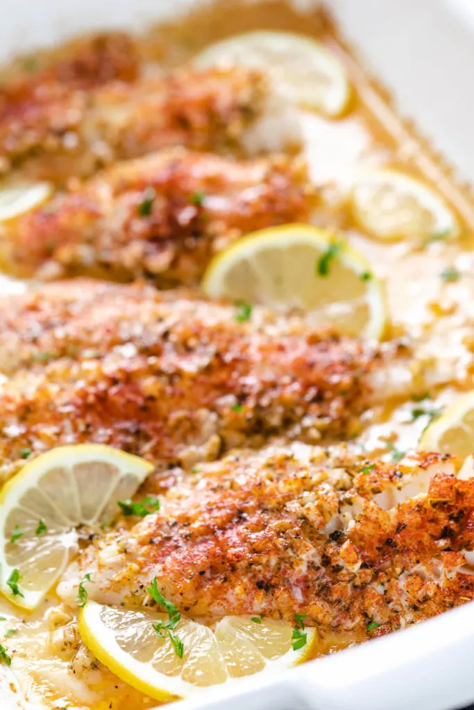 Seasoned white fish in a pan.