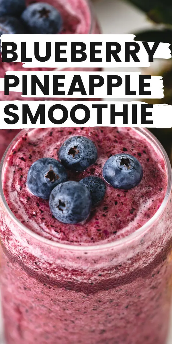 Close up view of a blueberry pineapple smoothie in a glass.
