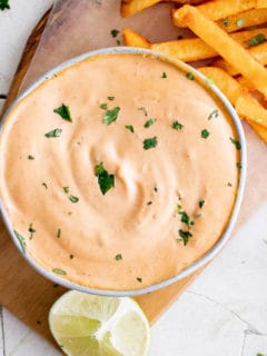 Close up of chipotle mayo and limes.