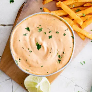 Close up of chipotle mayo and limes.