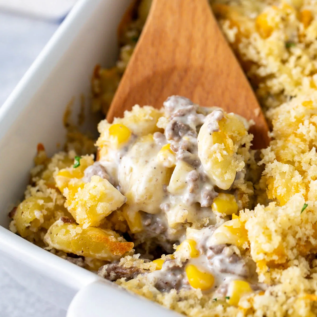 Close up view of hamburger corn casserole with breadcrumb topping.