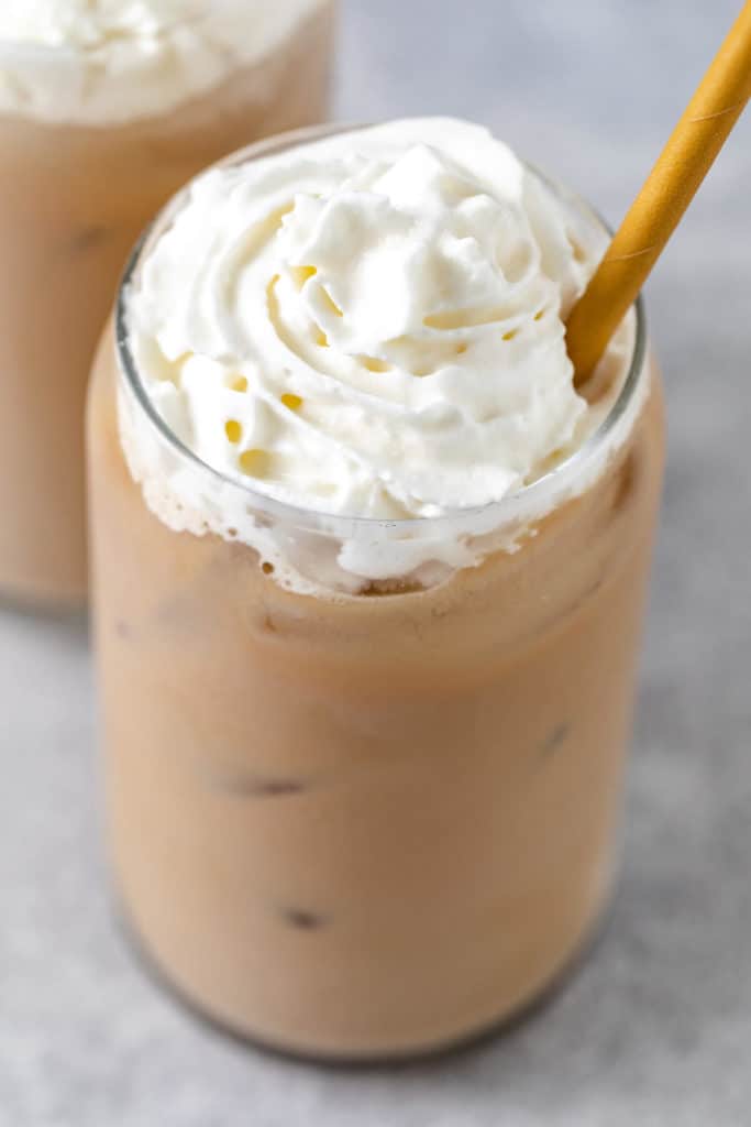 Close up view of an iced blonde vanilla latte in a glass.