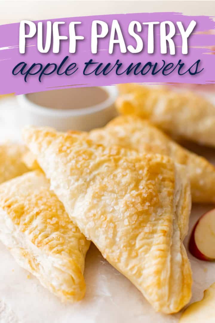 Close up view of fruit turnovers on parchment paper.