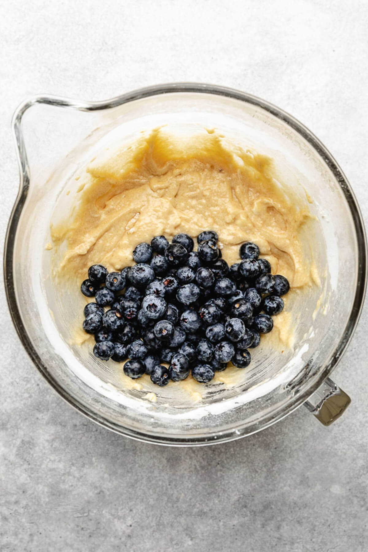 Fresh blueberries on top of muffin batter.